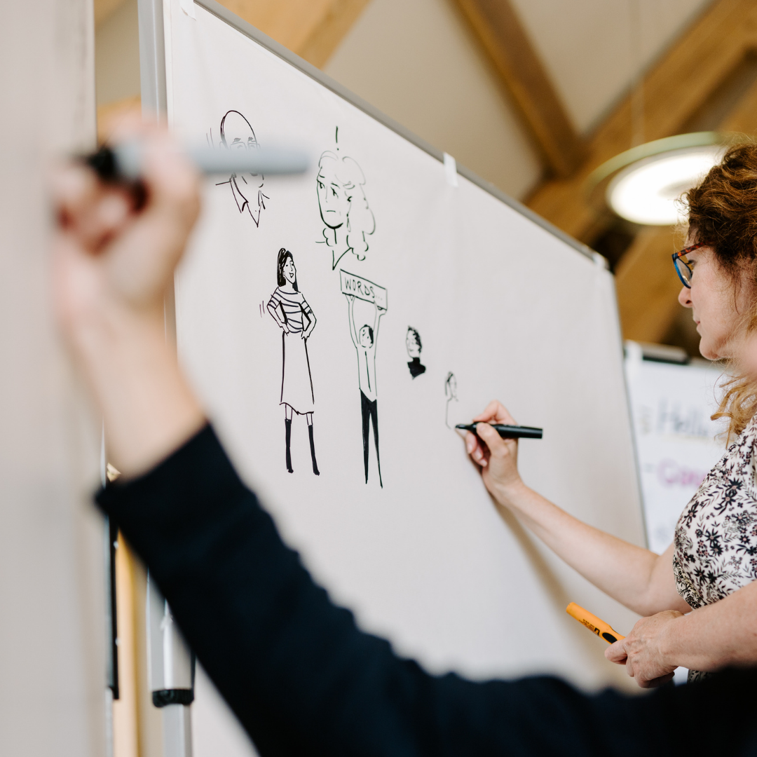 Photo of team of graphic artists from Inky Thinking drawing on Neuland Pinboards.