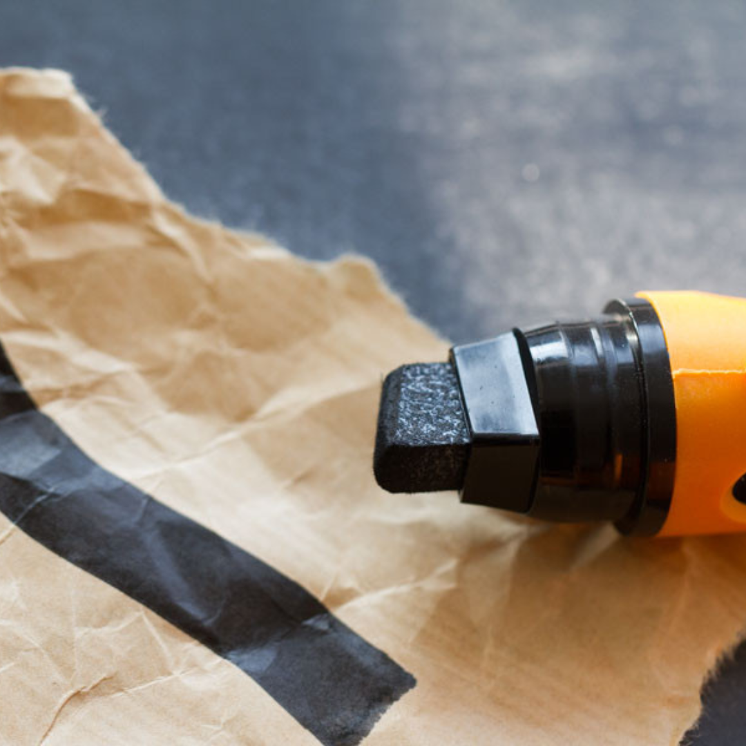 Photo of Neuland BigOne Wedge Outliner, black with line drawn on brown paper
