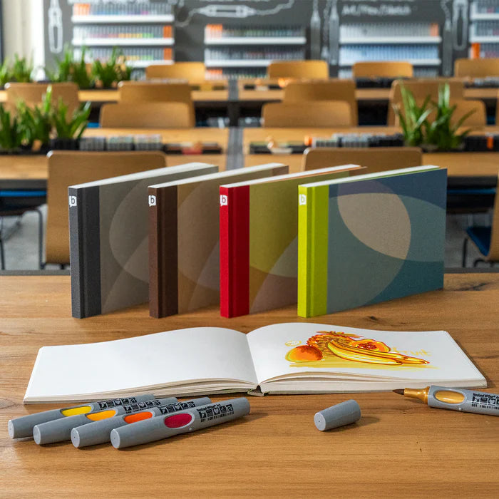 Colourful array of bikablo sketchnoter sketchbooks together with Neuland pens on desk. Sold by Inky Thinking UK.