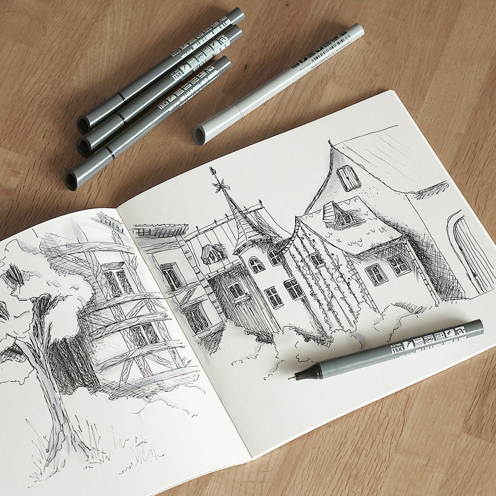 Open notebook with architectural drawings on a wooden surface with Neuland pens.