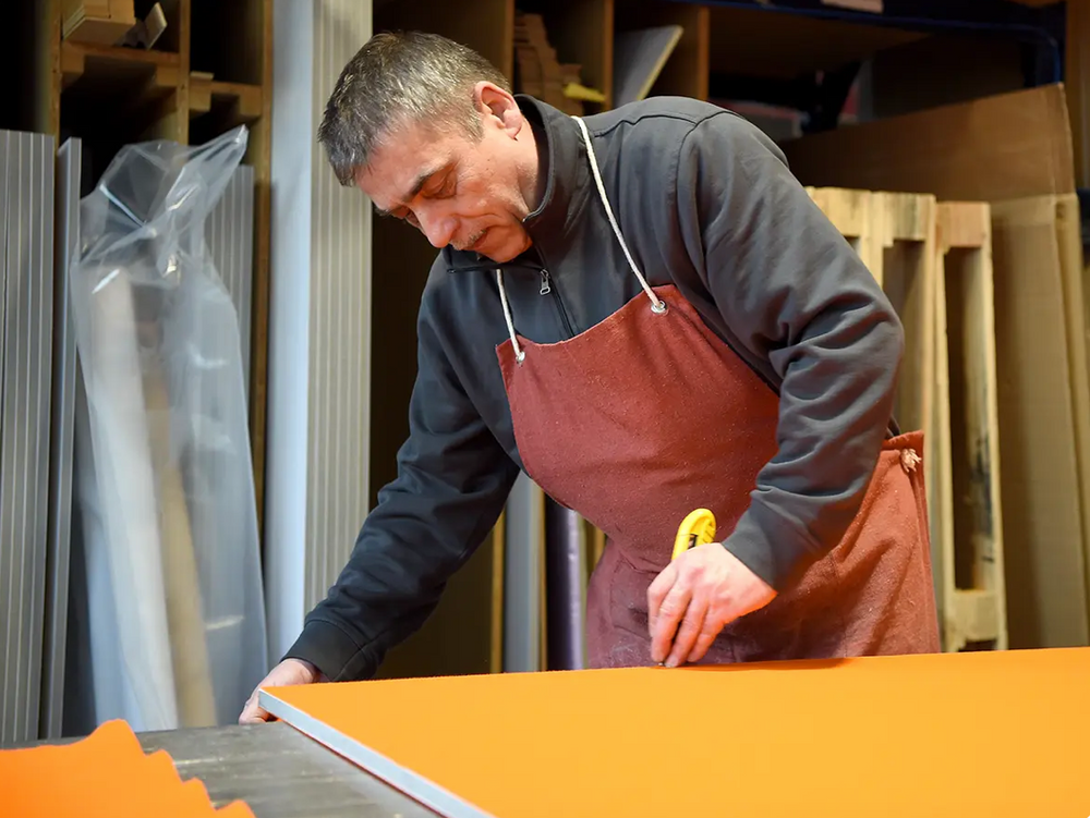 Man in production area working on Neuland EuroPin MC pinboard -  handmade in Germany